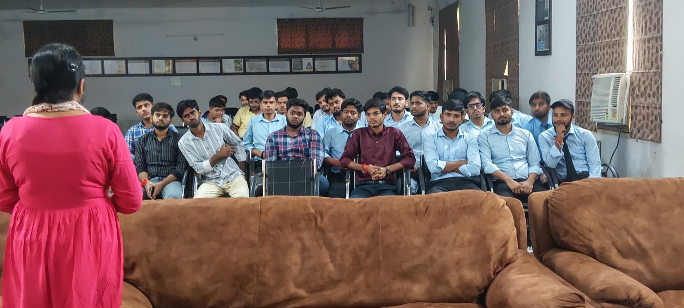 A faculty member addressing a group of seated students in the VCM seminar hall