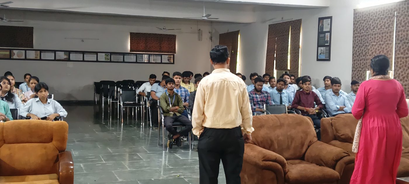 Two faculty members in discussion with seated students in the VCM seminar hall
